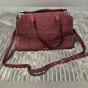 Rebecca Minkoff satchel in wine with crossbody strap and metal hardware/feet.